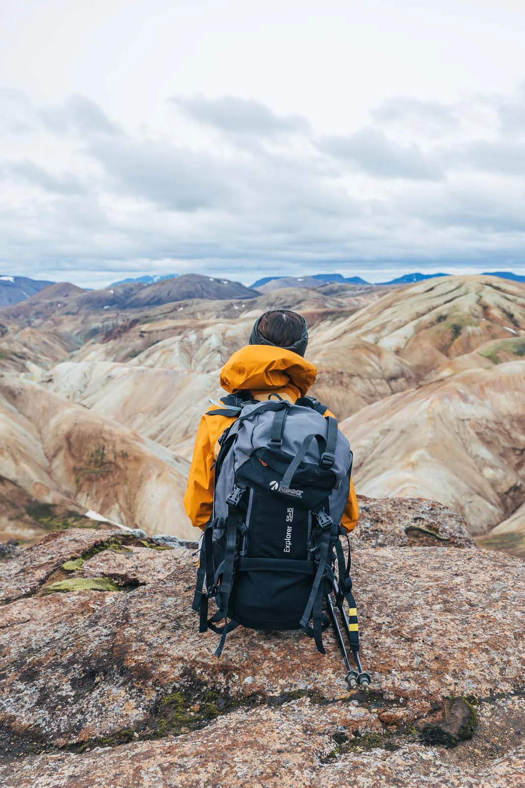 Wandelaar kijkt uit over golvende bergen