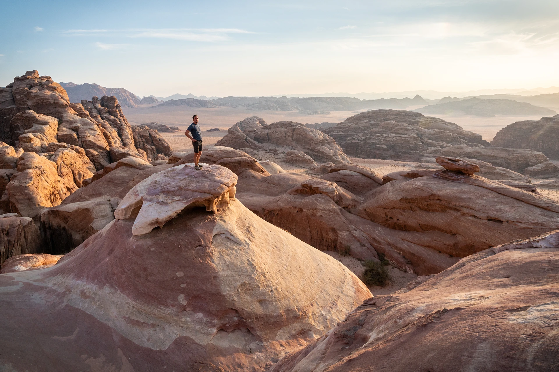 Hiker staat op rotsen met uitzicht over woestijnplateaus