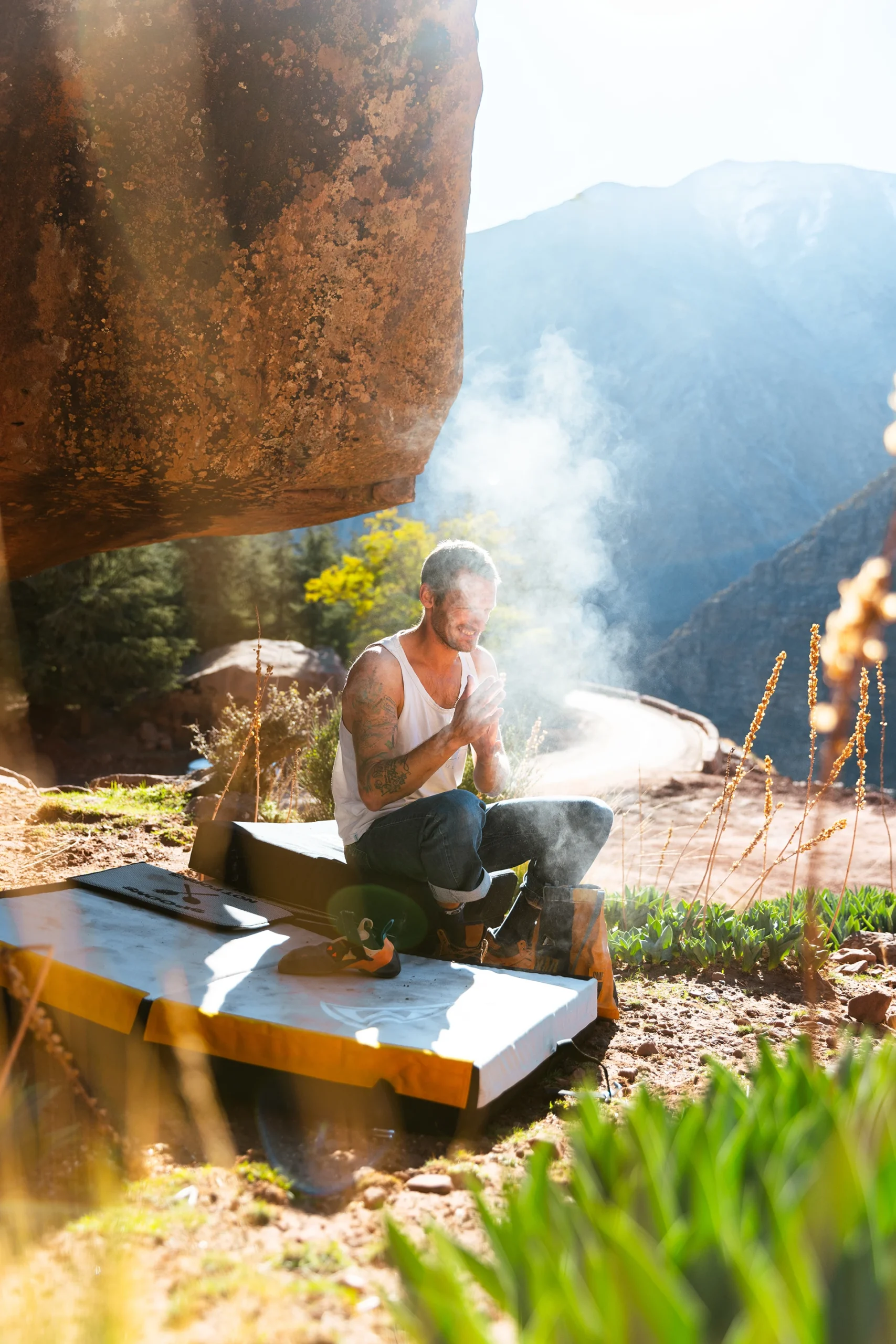 Kampvuur waar mensen koken onder schaduw van rotsen