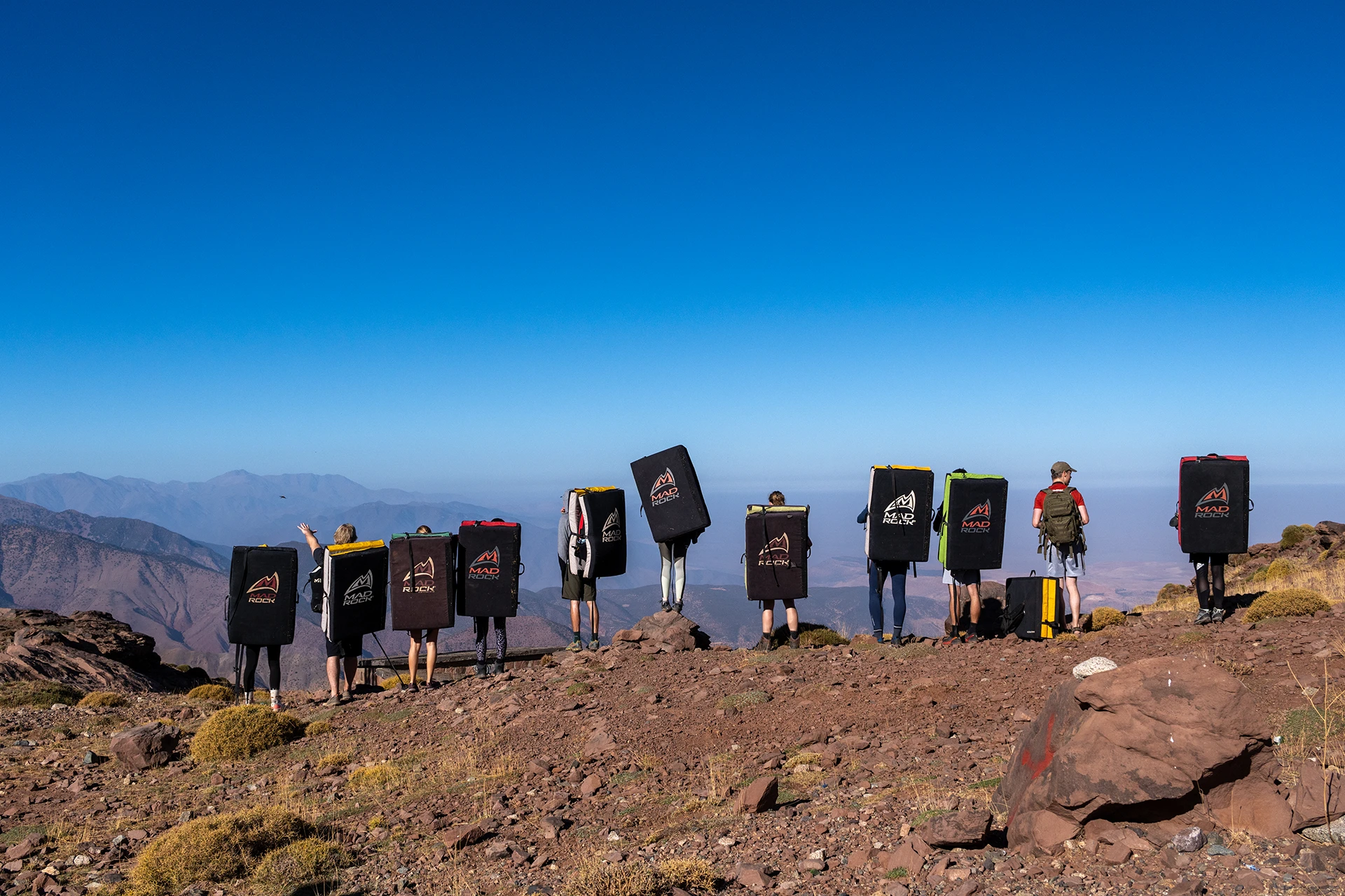 Groep hikers die met rugzakken op een bergplateau staat